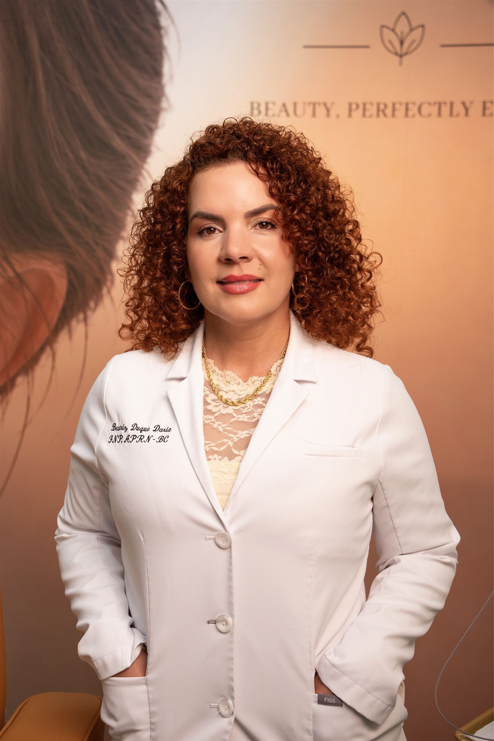 Portrait of Beatriz Duque Daria, FNP APRN-BC, in her white coat at The Edit