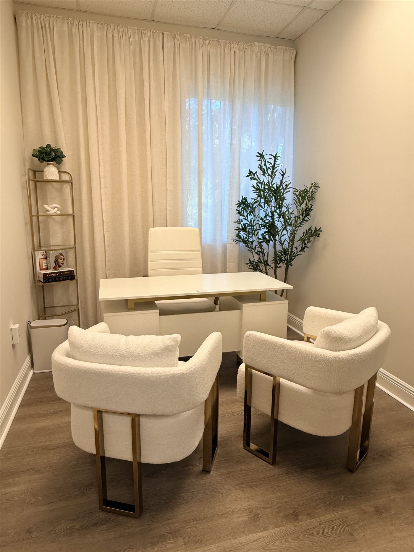 Consultation office at The Edit with cream boucle chairs on gold legs and a white desk